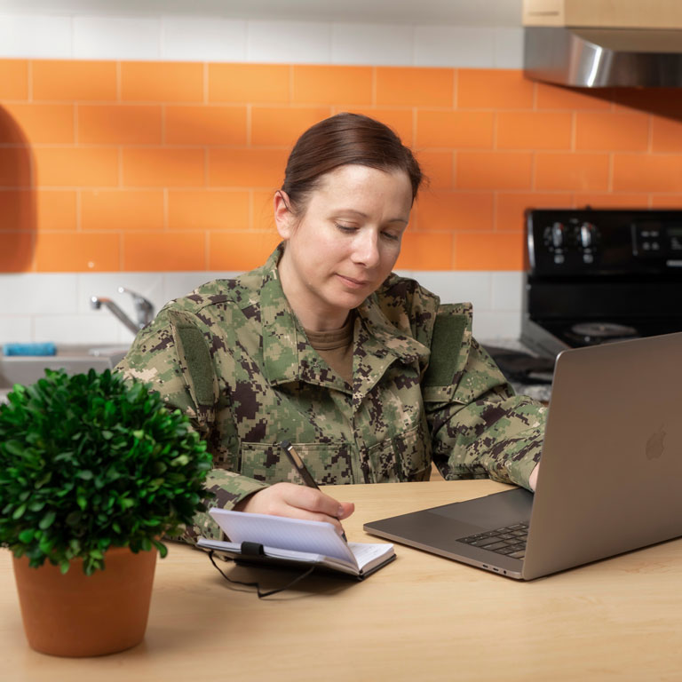 Student in fatigues working in kitchen